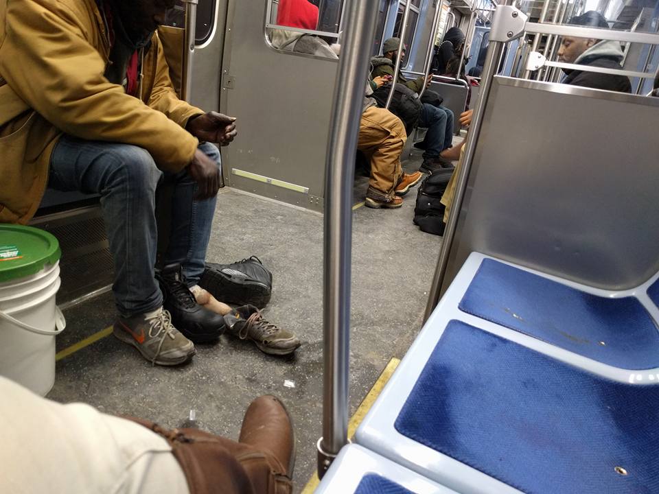 Young man gives homeless man on a CTA Red Line train the boots off his own feet.