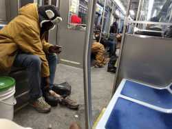 Young man gives homeless man on a CTA Red Line train the boots off his own feet.